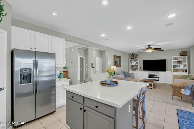 10391 E Malta St, Tucson, AZ 85747 - kitchen with white cabinets, stainless steel refrigerator with ice dispenser, a ceiling fan, and light tile patterned flooring