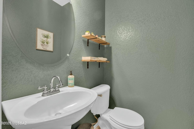10391 E Malta St, Tucson, AZ 85747 - half bathroom with a sink, a textured wall, and toilet