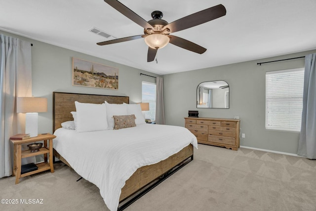 10391 E Malta St, Tucson, AZ 85747 - carpeted bedroom with visible vents, baseboards, ceiling fan, and multiple windows
