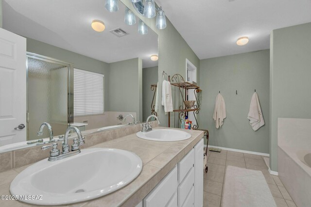10391 E Malta St, Tucson, AZ 85747 - bathroom featuring visible vents, a sink, a bath, and tile patterned flooring