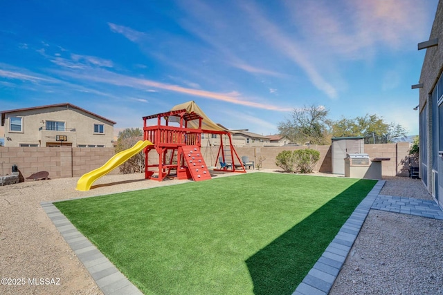 10391 E Malta St, Tucson, AZ 85747 - view of play area with a lawn, a fenced backyard, and an outdoor kitchen