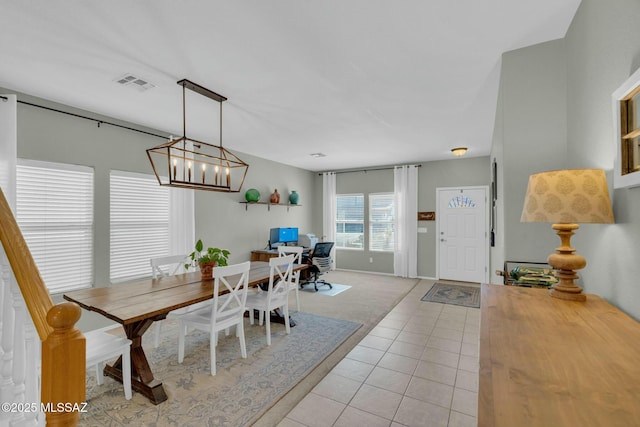10391 E Malta St, Tucson, AZ 85747 - dining space with light tile patterned floors, light colored carpet, a chandelier, and visible vents
