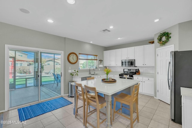 10391 E Malta St, Tucson, AZ 85747 - kitchen with appliances with stainless steel finishes, a sink, light countertops, tasteful backsplash, and visible vents