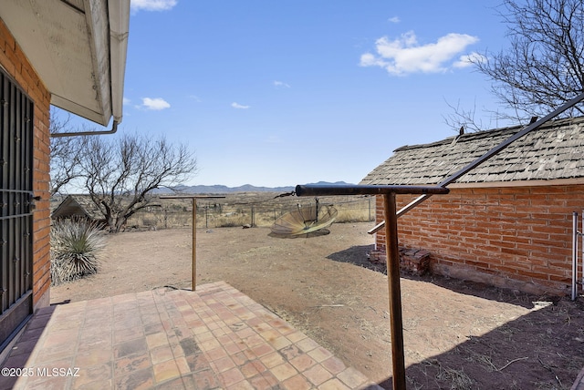 view of yard with a mountain view, a patio, and a fenced backyard