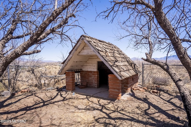 view of outbuilding featuring a mountain view and an outbuilding