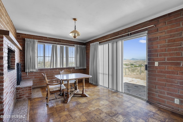 dining space featuring brick wall