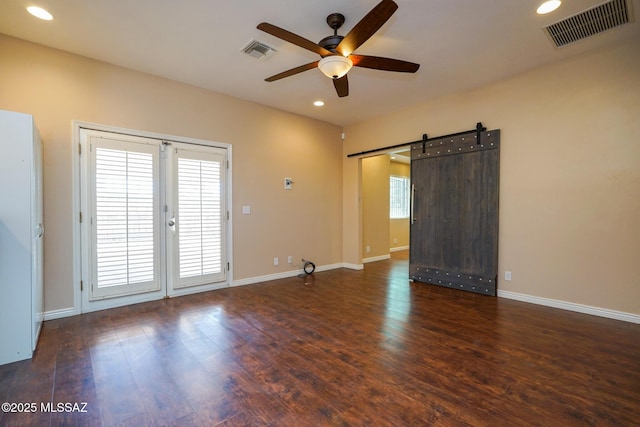 spare room with wood finished floors, a ceiling fan, visible vents, and recessed lighting