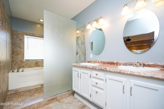 bathroom featuring a sink, a ceiling fan, double vanity, and a walk in shower