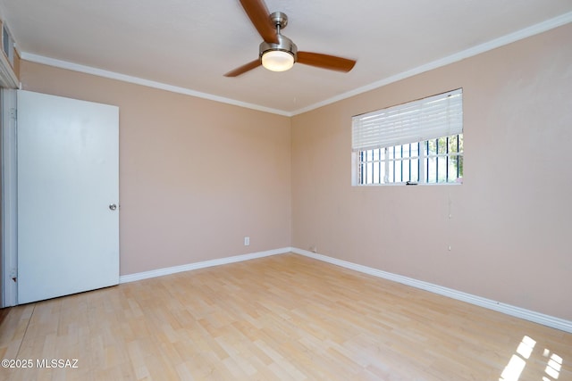 empty room with light wood finished floors, baseboards, crown molding, and a ceiling fan