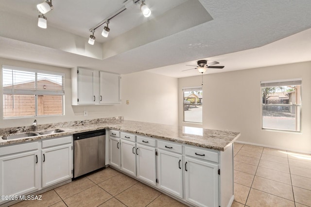kitchen with stainless steel dishwasher, light tile patterned floors, white cabinetry, a ceiling fan, and a peninsula