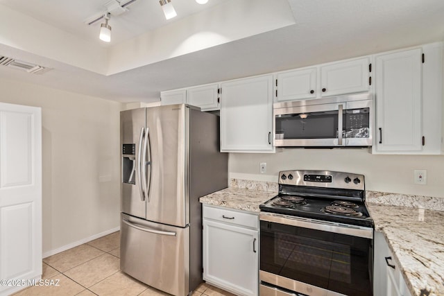 kitchen featuring light stone counters, light tile patterned floors, white cabinetry, appliances with stainless steel finishes, and visible vents