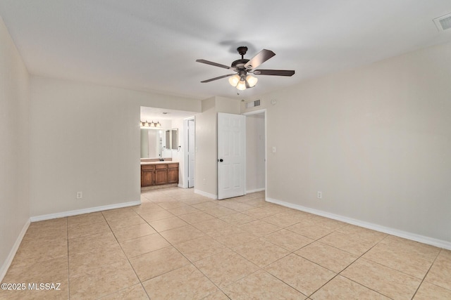 unfurnished room with light tile patterned floors, visible vents, ceiling fan, and baseboards