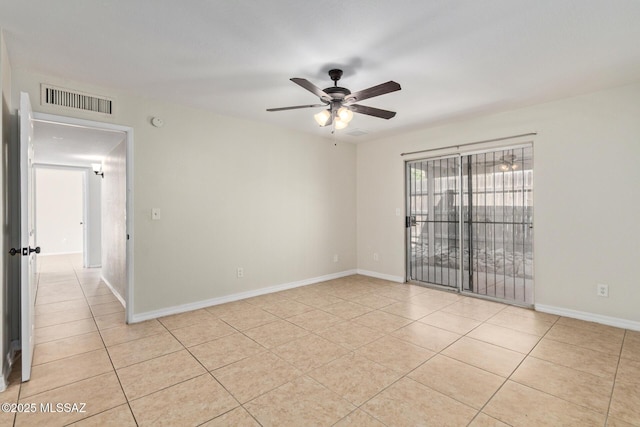 unfurnished room with baseboards, visible vents, light tile patterned floors, and a ceiling fan