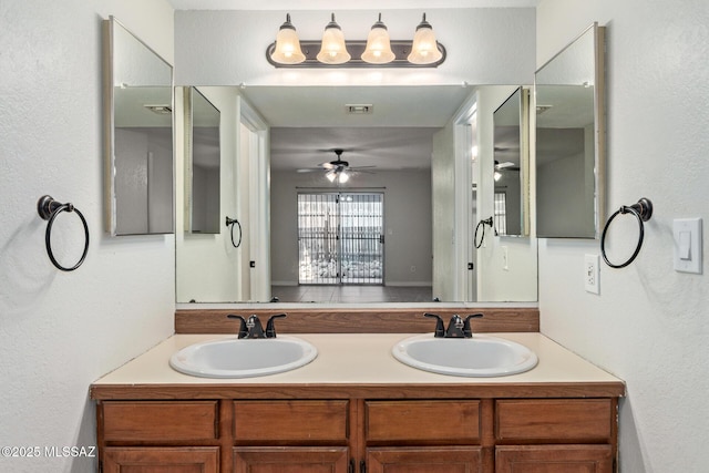 full bathroom featuring double vanity, a sink, and ceiling fan
