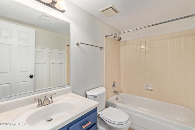 bathroom featuring visible vents, a textured wall, toilet, shower / bathing tub combination, and vanity