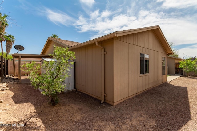 view of home's exterior featuring fence