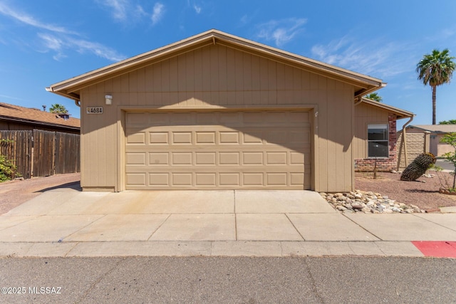 view of front of house with a garage and fence