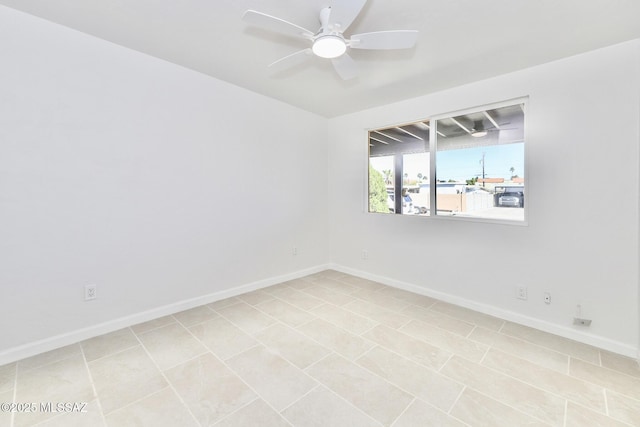 spare room with baseboards and a ceiling fan