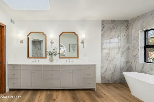 5788 E Paseo Cimarron, Tucson, AZ 85750 - full bath with double vanity, wood finished floors, and a freestanding bath