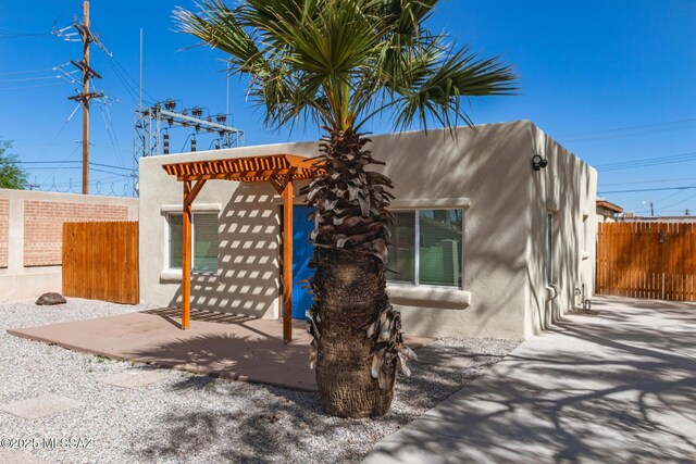 407 E 35th St, Tucson, AZ 85713 - view of front of house with stucco siding, fence, and a pergola