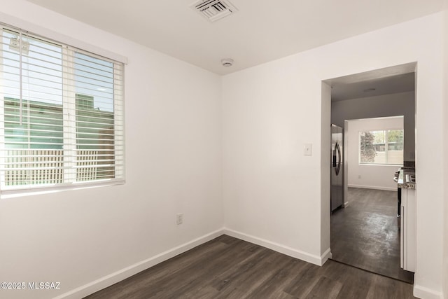 407 E 35th St, Tucson, AZ 85713 - unfurnished room with baseboards, visible vents, and dark wood-type flooring