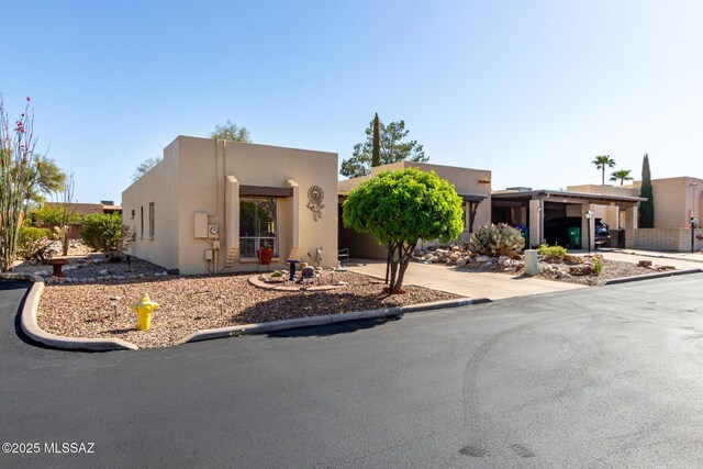 1379 W Camino Lucientes, Green Valley, AZ 85622 - southwest-style home featuring stucco siding, driveway, and an attached carport