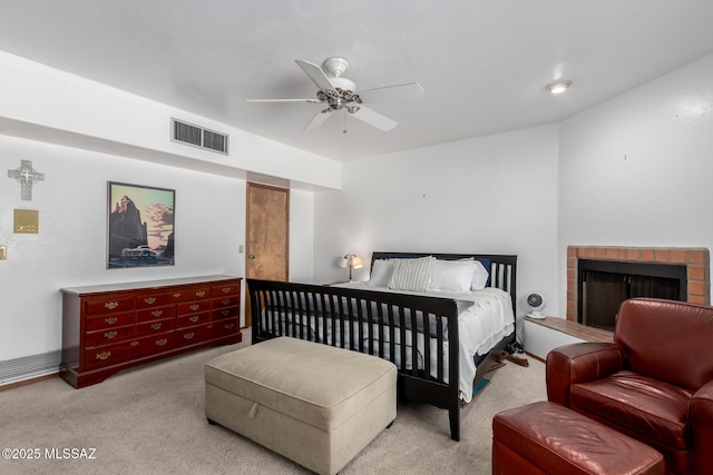 bedroom with visible vents, a ceiling fan, carpet flooring, and a fireplace