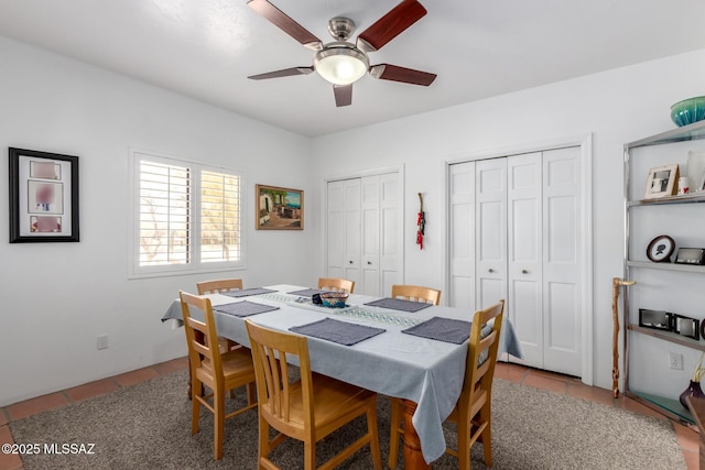 tiled dining area featuring ceiling fan