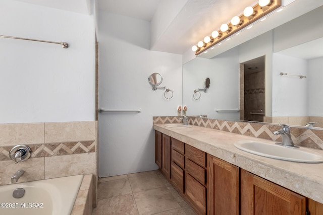 full bathroom with a sink, tile patterned floors, double vanity, and a bath
