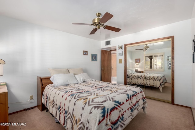 bedroom featuring ceiling fan, a closet, visible vents, carpet flooring, and baseboards