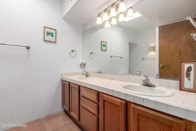 full bath featuring tile patterned floors, double vanity, and a sink