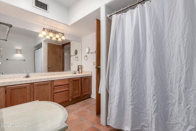 full bath with double vanity, tile patterned flooring, a shower with curtain, visible vents, and a sink