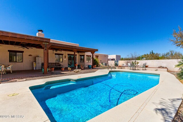 view of pool with ceiling fan, a patio area, a fenced in pool, and fence