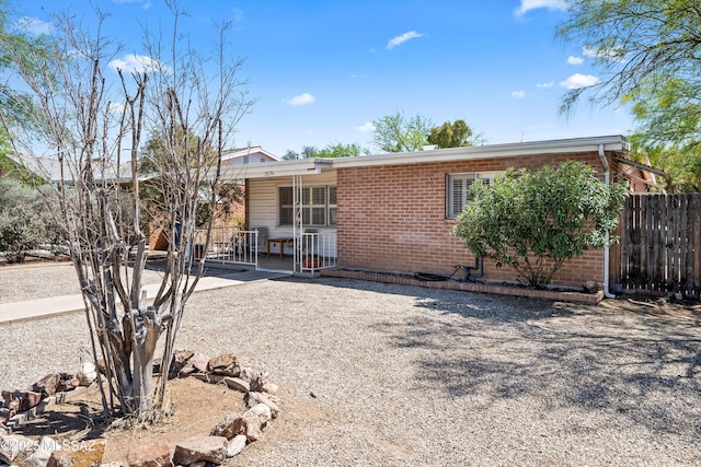 2636 E 5th St, Tucson, AZ 85716 - view of front of property with brick siding, fence, and covered porch