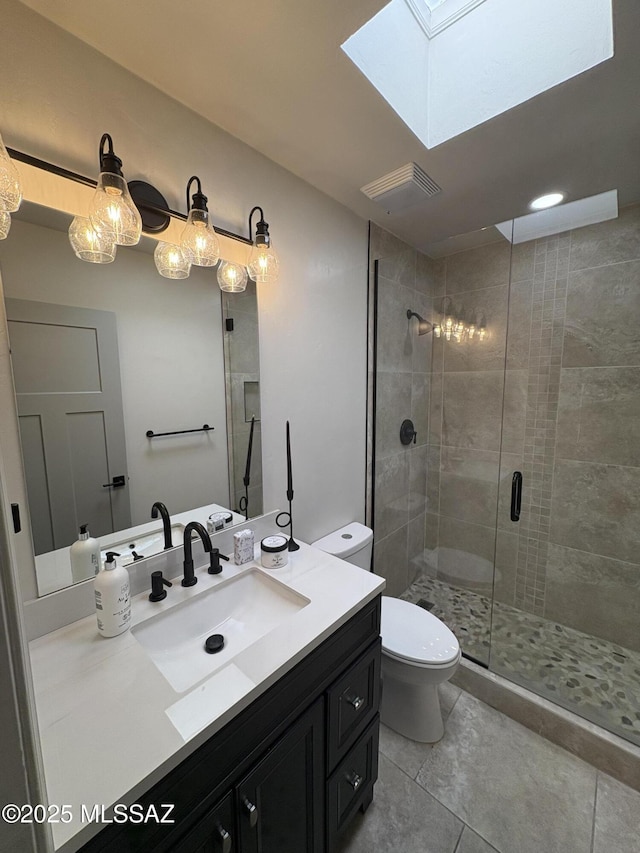 4250 E Aquarius Dr, Tucson, AZ 85718 - full bathroom with a stall shower, toilet, a skylight, vanity, and tile patterned flooring
