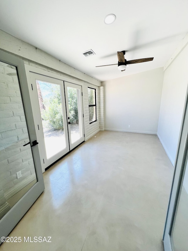 4250 E Aquarius Dr, Tucson, AZ 85718 - empty room with french doors, finished concrete flooring, a ceiling fan, and baseboards