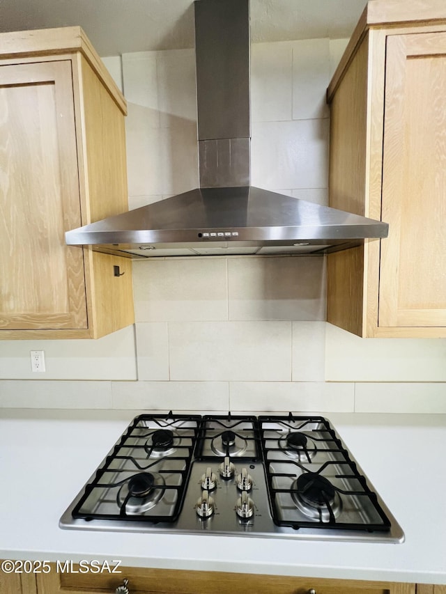 4250 E Aquarius Dr, Tucson, AZ 85718 - kitchen view of wall chimney exhaust hood, stainless steel gas stovetop, decorative backsplash, and light brown cabinets