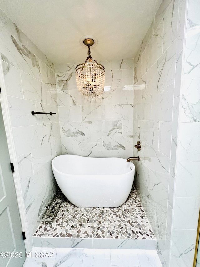 4250 E Aquarius Dr, Tucson, AZ 85718 - full bathroom with marble look tiles, a soaking tub, a chandelier, tiled shower, and tile walls