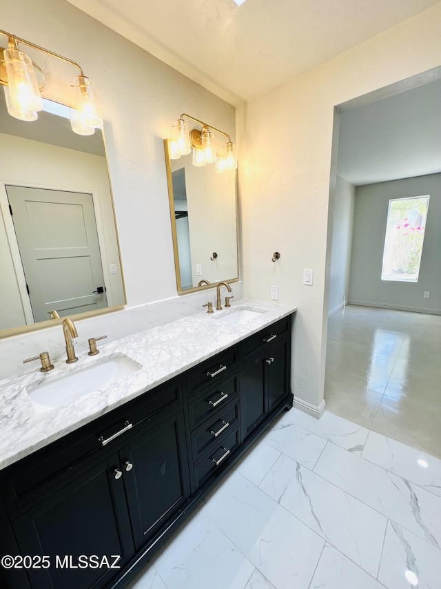4250 E Aquarius Dr, Tucson, AZ 85718 - full bathroom featuring double vanity, marble look tiles, and baseboards