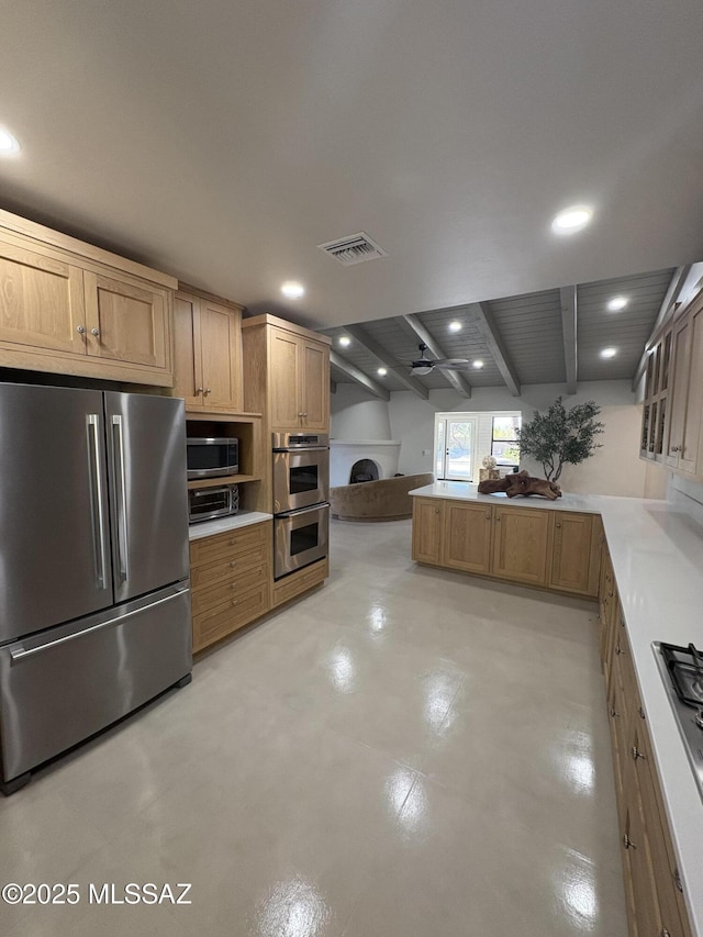 4250 E Aquarius Dr, Tucson, AZ 85718 - kitchen with stainless steel appliances, recessed lighting, a peninsula, a fireplace, and finished concrete floors