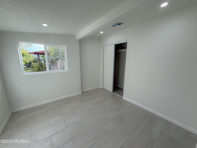 unfurnished bedroom featuring visible vents, baseboards, recessed lighting, and a closet