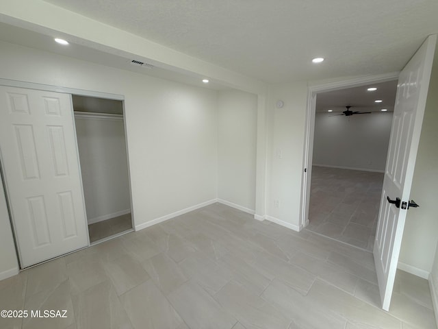 unfurnished bedroom featuring a closet, baseboards, visible vents, and recessed lighting