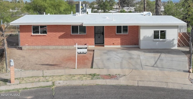 single story home with fence and brick siding