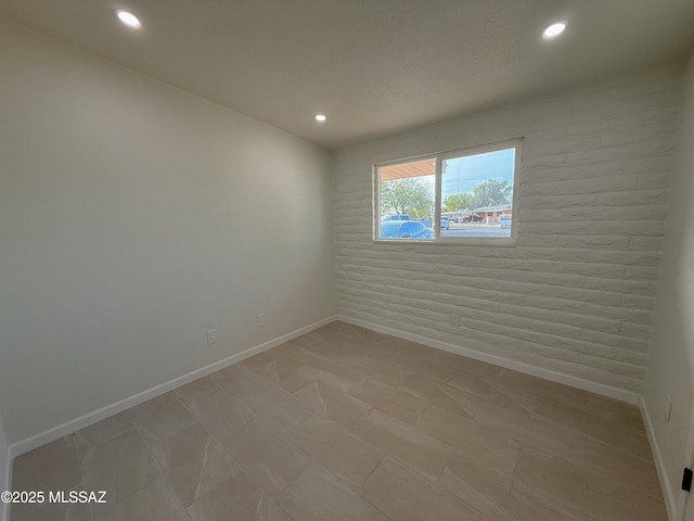 unfurnished room with baseboards and recessed lighting