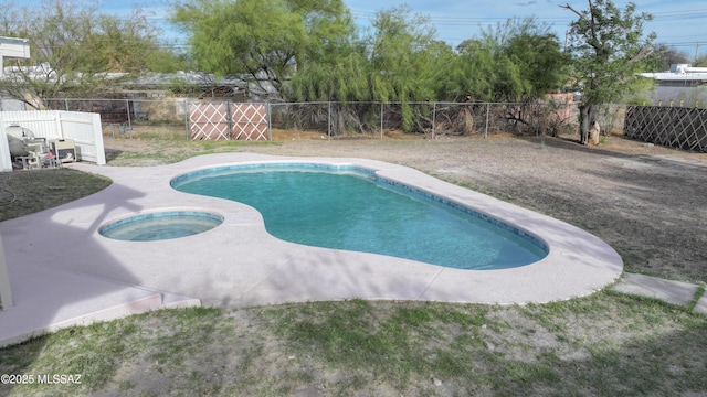 view of swimming pool with a fenced backyard, a fenced in pool, and an in ground hot tub