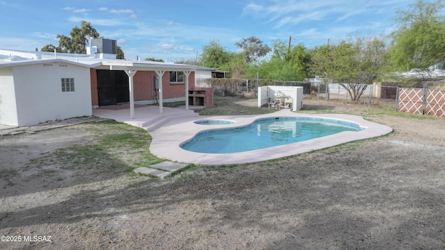 view of swimming pool with a fenced in pool, a patio area, fence private yard, and a jacuzzi