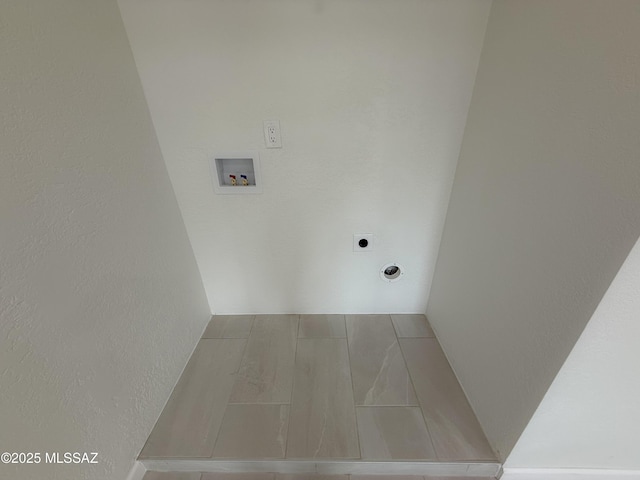 laundry area with laundry area, hookup for a washing machine, and electric dryer hookup