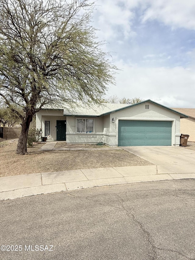 single story home with driveway, stucco siding, and an attached garage