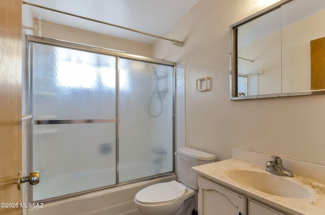 full bath featuring combined bath / shower with glass door, vanity, and toilet