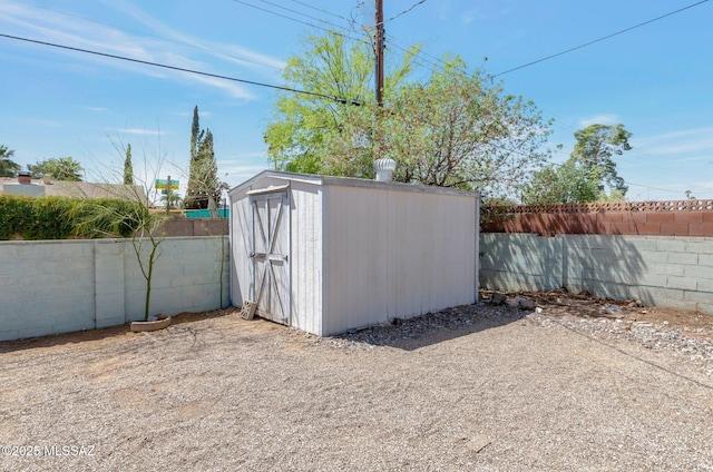 view of shed with a fenced backyard